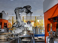 A robotic arm produces optical core products in an unmanned workshop at an enterprise in the Zaozhuang Economic Development Zone in Zaozhuan...