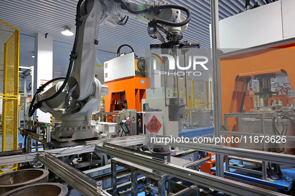 A robotic arm produces optical core products in an unmanned workshop at an enterprise in the Zaozhuang Economic Development Zone in Zaozhuan...