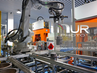 A robotic arm produces optical core products in an unmanned workshop at an enterprise in the Zaozhuang Economic Development Zone in Zaozhuan...