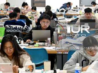 Students prepare for the 2025 national postgraduate entrance exam at Hebei University of Engineering in Handan, China, on December 16, 2024....