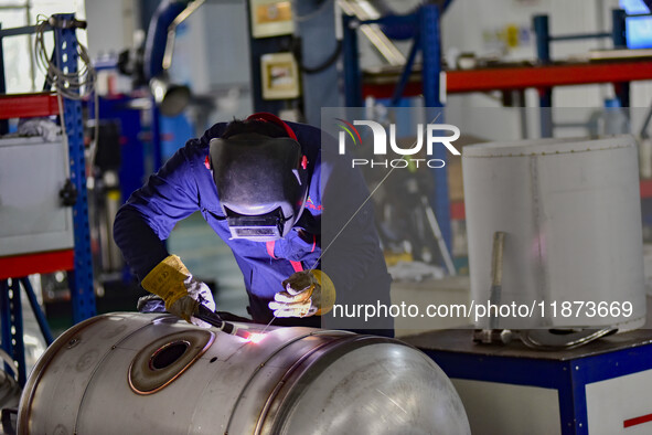 A worker works at a workshop of a water supply equipment manufacturing company in Qingzhou, China, on December 16, 2024. 