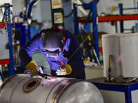 A worker works at a workshop of a water supply equipment manufacturing company in Qingzhou, China, on December 16, 2024. (