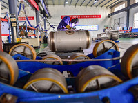 A worker works at a workshop of a water supply equipment manufacturing company in Qingzhou, China, on December 16, 2024. (