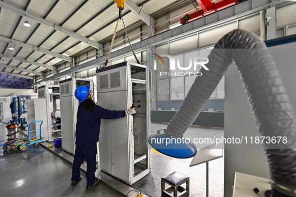 A worker works at a workshop of a water supply equipment manufacturing company in Qingzhou, China, on December 16, 2024. 