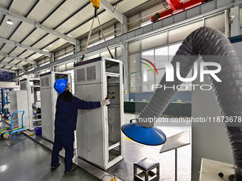 A worker works at a workshop of a water supply equipment manufacturing company in Qingzhou, China, on December 16, 2024. (