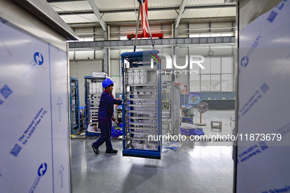 A worker works at a workshop of a water supply equipment manufacturing company in Qingzhou, China, on December 16, 2024. 