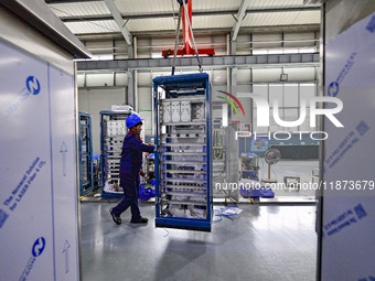 A worker works at a workshop of a water supply equipment manufacturing company in Qingzhou, China, on December 16, 2024. (