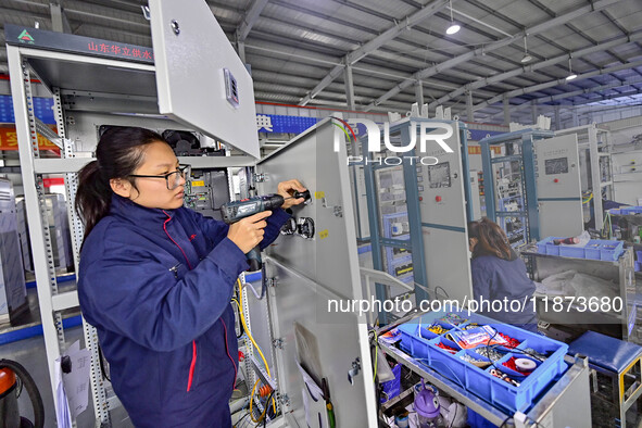 A worker works at a workshop of a water supply equipment manufacturing company in Qingzhou, China, on December 16, 2024. 