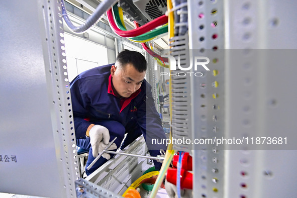 A worker works at a workshop of a water supply equipment manufacturing company in Qingzhou, China, on December 16, 2024. 