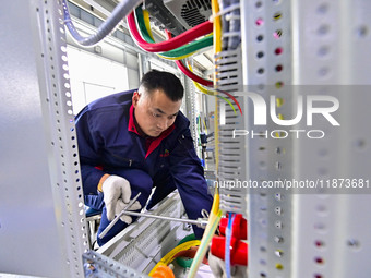 A worker works at a workshop of a water supply equipment manufacturing company in Qingzhou, China, on December 16, 2024. (