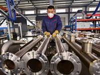 A worker works at a workshop of a water supply equipment manufacturing company in Qingzhou, China, on December 16, 2024. (