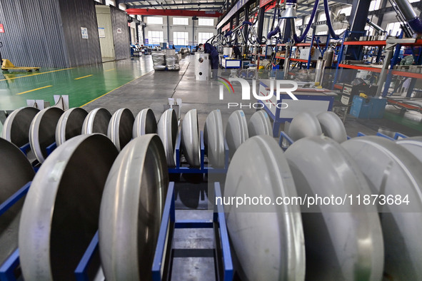 A worker works at a workshop of a water supply equipment manufacturing company in Qingzhou, China, on December 16, 2024. 