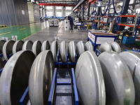 A worker works at a workshop of a water supply equipment manufacturing company in Qingzhou, China, on December 16, 2024. (