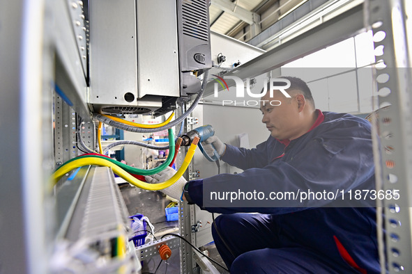 A worker works at a workshop of a water supply equipment manufacturing company in Qingzhou, China, on December 16, 2024. 