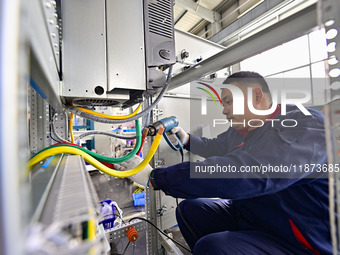 A worker works at a workshop of a water supply equipment manufacturing company in Qingzhou, China, on December 16, 2024. (