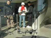 Customers try out drone products at the DJI flagship store in Shanghai, China, on December 16, 2024. (