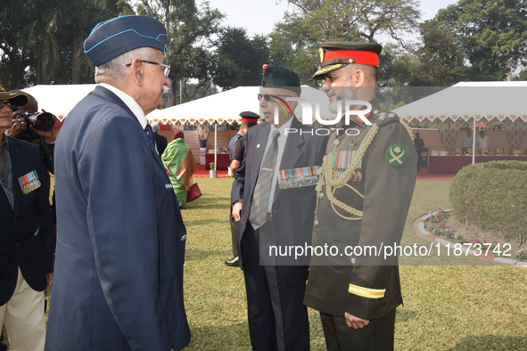 Bangladesh military officer Aminur Rahman (right) and Indian retired officer delegates place a wreath and pay tribute on the occasion of 'Vi...