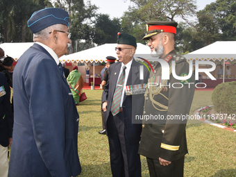 Bangladesh military officer Aminur Rahman (right) and Indian retired officer delegates place a wreath and pay tribute on the occasion of 'Vi...