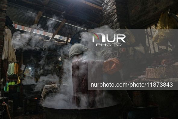 Ashiq Hussain Posh dyes threads inside a dyeing center in Srinagar, Jammu and Kashmir, on December 16, 2024. Kashmiris dye fabric and thread...