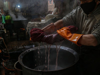 Waseem Khan dyes threads inside a dyeing center in Srinagar, Jammu and Kashmir, on December 16, 2024. Kashmiris dye fabric and threads manua...