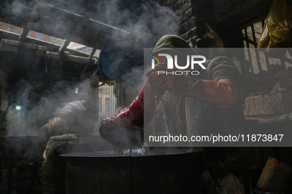 Ashiq Hussain Posh dyes threads inside a dyeing center in Srinagar, Jammu and Kashmir, on December 16, 2024. Kashmiris dye fabric and thread...