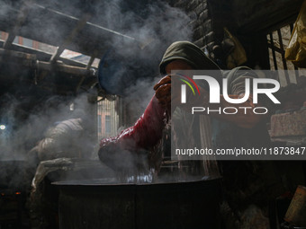 Ashiq Hussain Posh dyes threads inside a dyeing center in Srinagar, Jammu and Kashmir, on December 16, 2024. Kashmiris dye fabric and thread...