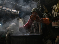 Ashiq Hussain Posh dyes threads inside a dyeing center in Srinagar, Jammu and Kashmir, on December 16, 2024. Kashmiris dye fabric and thread...