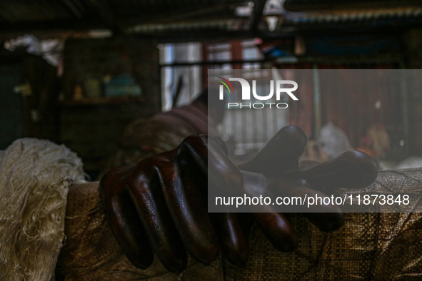 Gloves used while working on threads are left to air dry inside a dyeing center in Srinagar, Jammu and Kashmir, on December 16, 2024. Kashmi...