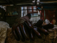 Gloves used while working on threads are left to air dry inside a dyeing center in Srinagar, Jammu and Kashmir, on December 16, 2024. Kashmi...