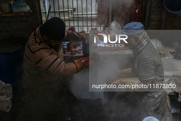 Farooq Ahmad (right) and Tariq Ahmad Posh (left) dye threads inside a dyeing center in Srinagar, Jammu and Kashmir, on December 16, 2024. Ka...