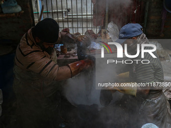 Farooq Ahmad (right) and Tariq Ahmad Posh (left) dye threads inside a dyeing center in Srinagar, Jammu and Kashmir, on December 16, 2024. Ka...