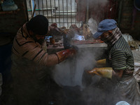 Farooq Ahmad (right) and Tariq Ahmad Posh (left) dye threads inside a dyeing center in Srinagar, Jammu and Kashmir, on December 16, 2024. Ka...