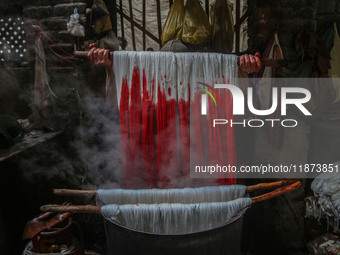 Ashiq Hussain Posh dyes threads inside a dyeing center in Srinagar, Jammu and Kashmir, on December 16, 2024. Kashmiris dye fabric and thread...