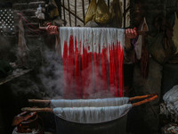 Ashiq Hussain Posh dyes threads inside a dyeing center in Srinagar, Jammu and Kashmir, on December 16, 2024. Kashmiris dye fabric and thread...