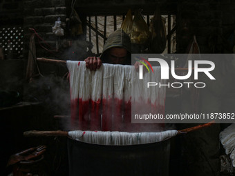 Ashiq Hussain Posh dyes threads inside a dyeing center in Srinagar, Jammu and Kashmir, on December 16, 2024. Kashmiris dye fabric and thread...