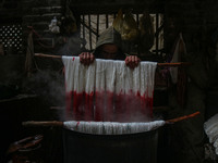 Ashiq Hussain Posh dyes threads inside a dyeing center in Srinagar, Jammu and Kashmir, on December 16, 2024. Kashmiris dye fabric and thread...