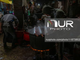 Ashiq Hussain Posh (right) and Waseem Khan (left) dye threads inside a dyeing center in Srinagar, Jammu and Kashmir, on December 16, 2024. K...