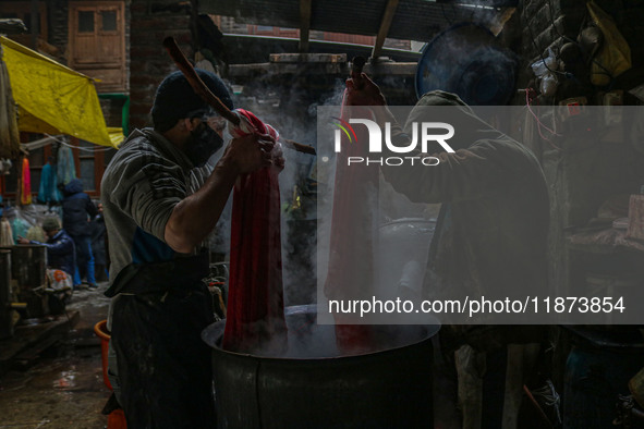 Ashiq Hussain Posh (right) and Waseem Khan (left) dye threads inside a dyeing center in Srinagar, Jammu and Kashmir, on December 16, 2024. K...