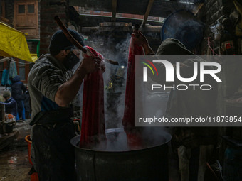 Ashiq Hussain Posh (right) and Waseem Khan (left) dye threads inside a dyeing center in Srinagar, Jammu and Kashmir, on December 16, 2024. K...