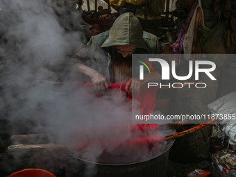 Ashiq Hussain Posh dyes threads inside a dyeing center in Srinagar, Jammu and Kashmir, on December 16, 2024. Kashmiris dye fabric and thread...