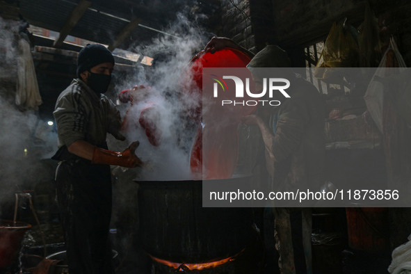 Ashiq Hussain Posh (right) and Waseem Khan (left) dye threads inside a dyeing center in Srinagar, Jammu and Kashmir, on December 16, 2024. K...