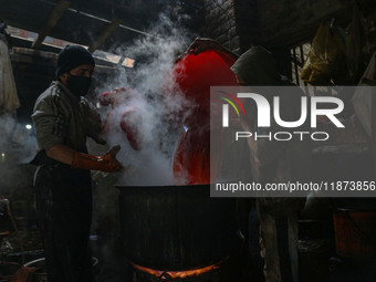 Ashiq Hussain Posh (right) and Waseem Khan (left) dye threads inside a dyeing center in Srinagar, Jammu and Kashmir, on December 16, 2024. K...