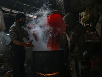 Ashiq Hussain Posh (right) and Waseem Khan (left) dye threads inside a dyeing center in Srinagar, Jammu and Kashmir, on December 16, 2024. K...