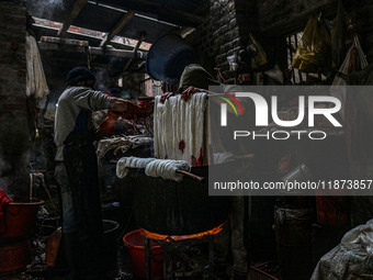 Ashiq Hussain Posh (right) and Waseem Khan (left) dye threads inside a dyeing center in Srinagar, Jammu and Kashmir, on December 16, 2024. K...