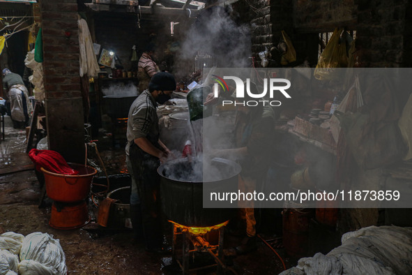 Ashiq Hussain Posh (right) and Waseem Khan (left) dye threads inside a dyeing center in Srinagar, Jammu and Kashmir, on December 16, 2024. K...