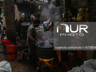 Ashiq Hussain Posh (right) and Waseem Khan (left) dye threads inside a dyeing center in Srinagar, Jammu and Kashmir, on December 16, 2024. K...