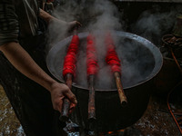 Waseem Khan dyes threads inside a dyeing center in Srinagar, Jammu and Kashmir, on December 16, 2024. Kashmiris dye fabric and threads manua...