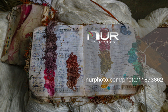 A notebook used for daily orders is seen inside a dyeing center in Srinagar, Jammu and Kashmir, on December 16, 2024. Kashmiris dye fabric a...