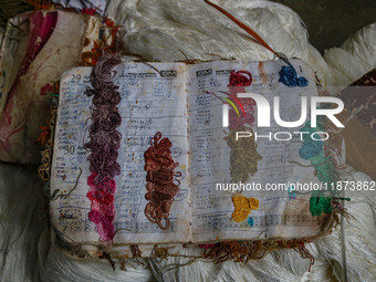 A notebook used for daily orders is seen inside a dyeing center in Srinagar, Jammu and Kashmir, on December 16, 2024. Kashmiris dye fabric a...