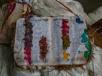 A notebook used for daily orders is seen inside a dyeing center in Srinagar, Jammu and Kashmir, on December 16, 2024. Kashmiris dye fabric a...